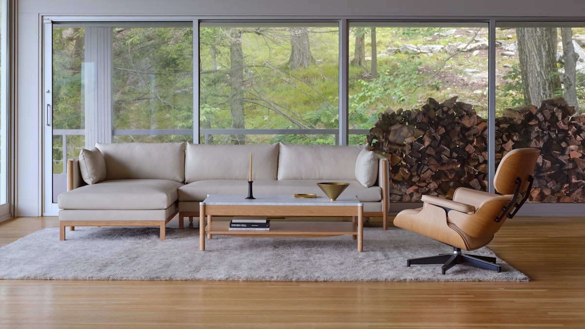 Emmy Sectional and Eames Lounge Chair and Ottoman in a living room setting